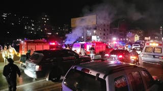 First responders rush to the site where a vehicle was targeted by an Israeli airstrike in the area of Khalde south of Beirut on April 1, 2026. (Photo by Fadel ITANI / AFP via Getty Images) /